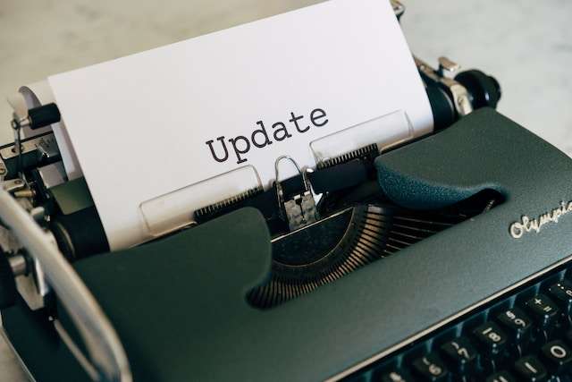 Typewriter with paper coming out of the top that has typed text: "Update"